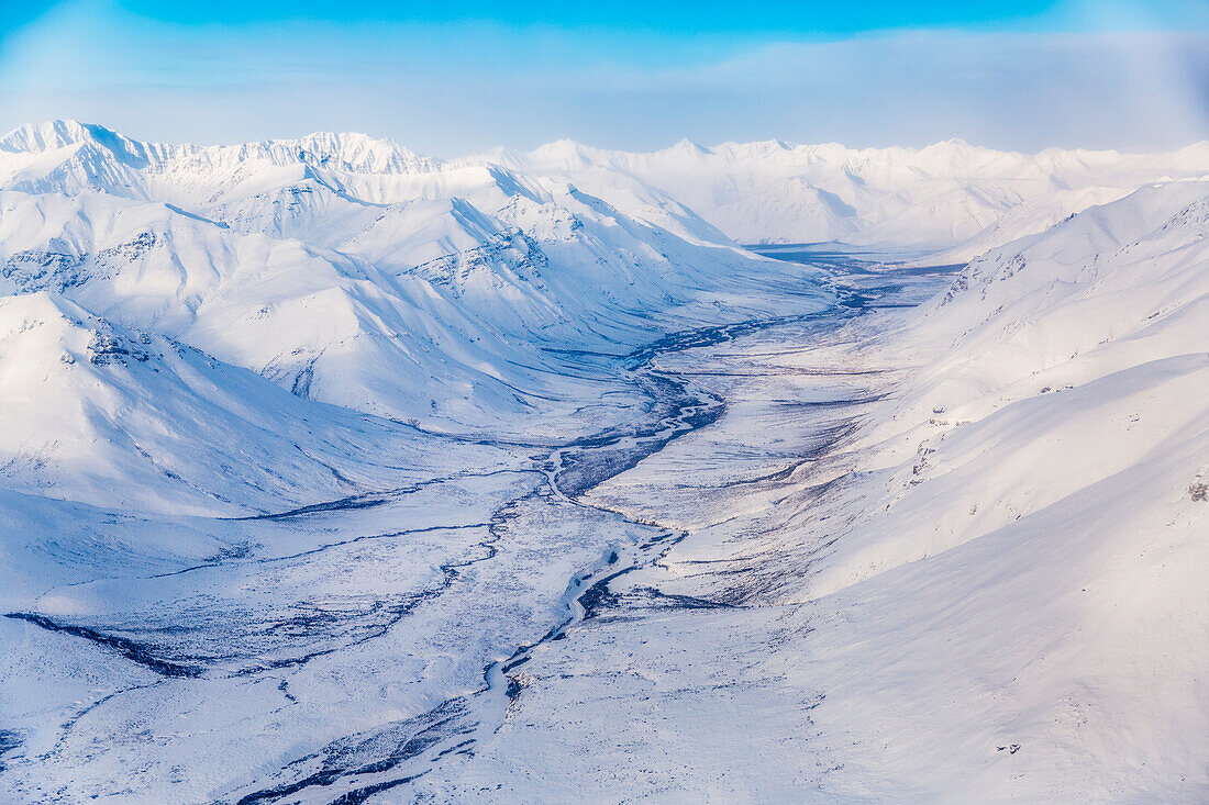 Aerial view of a snow-covered valley and the Brooks Range, Arctic Alaska, USA