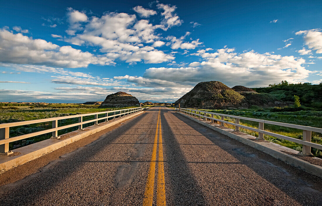 'Double solid yellow line down a paved road; Herschel, Saskatchewan, Canada'