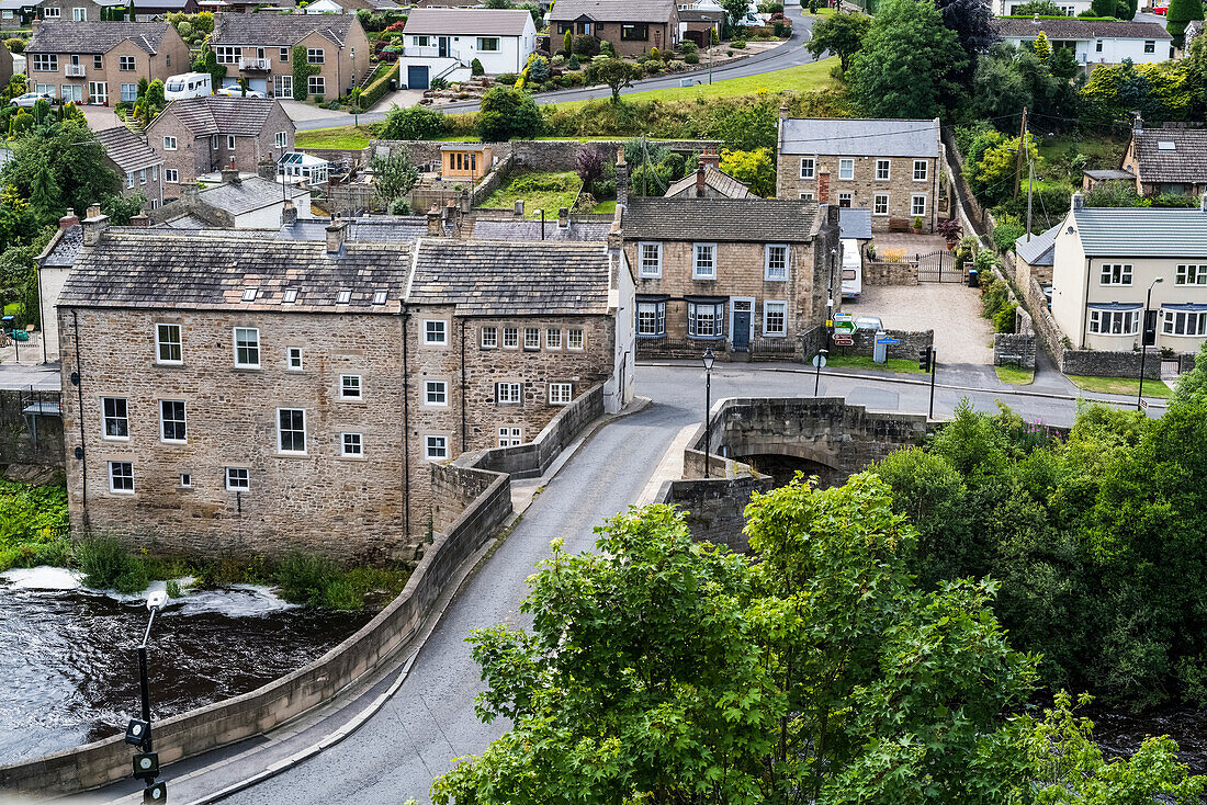 'A street crossing a river and residential buildings; Barnard Castle, Durham, England'
