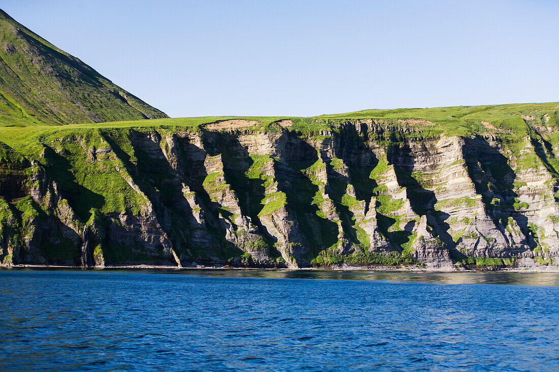 'The Pallisade Cliffs In Ikatan Bay Of False Pass, Also Known As Isanotski Strait, In Summertime; Southwest Alaska, United States Of America'