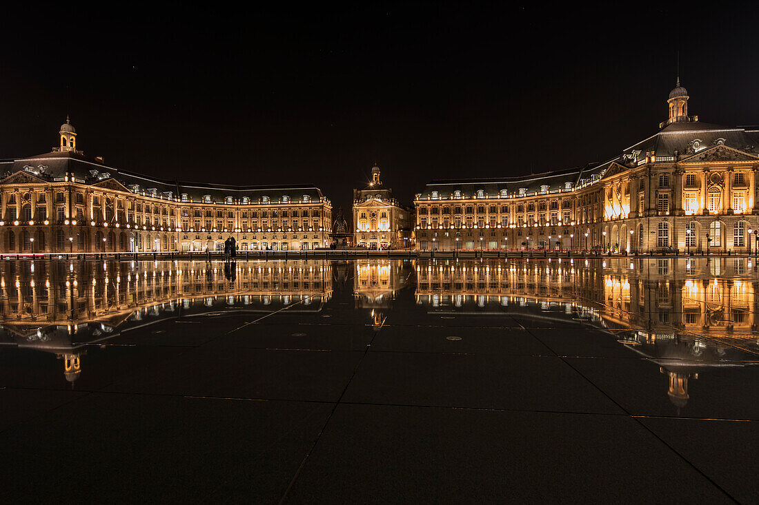 Place de la Bourse is reflected in the Miroir d'eau fountain at night