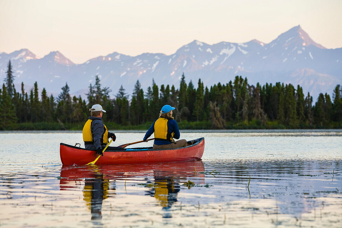 A couple canoeing on Stone Step Lake, Homer, Alaska, United States of America