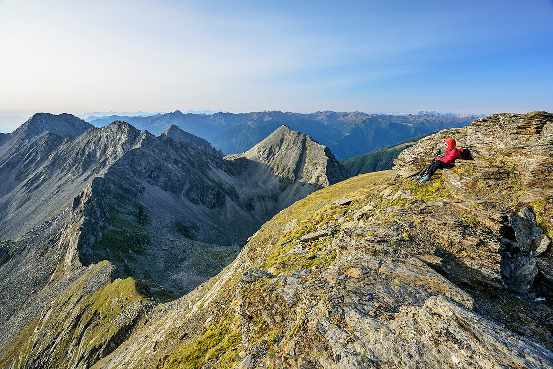 Woman hiking sitting at Feldseekopf, Feldseekopf, Tauern ridgeway, High Tauern range, Salzburg, Austria