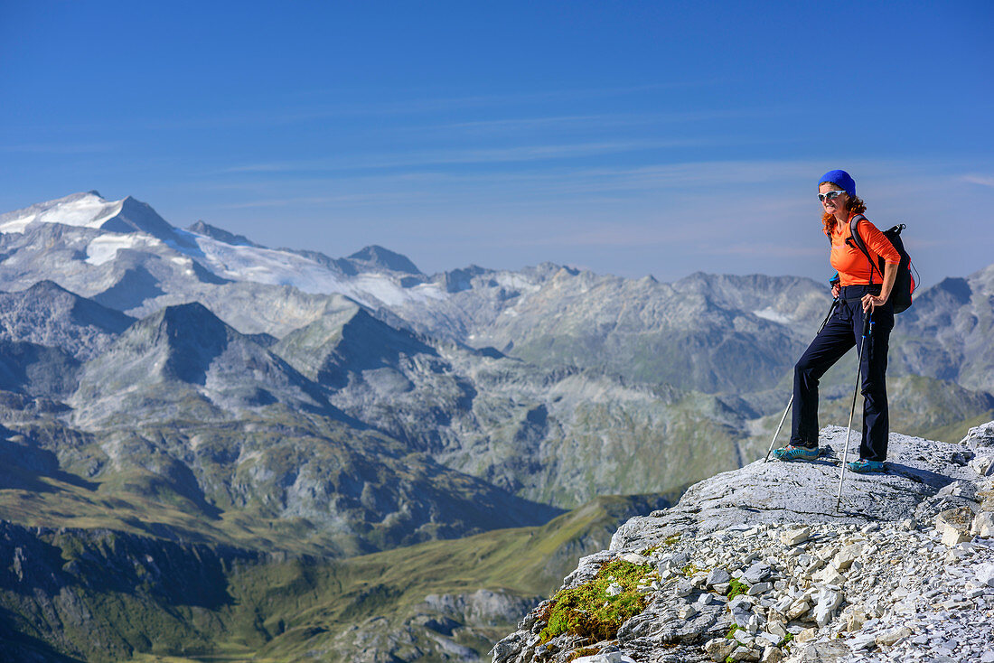 Woman hiking standing at summit of Grosses Mosermandl, Hochalmspitze in background, Grosses Mosermandl, valley Riedingtal, Radstadt Tauern, Lower Tauern, Carinthia, Austria