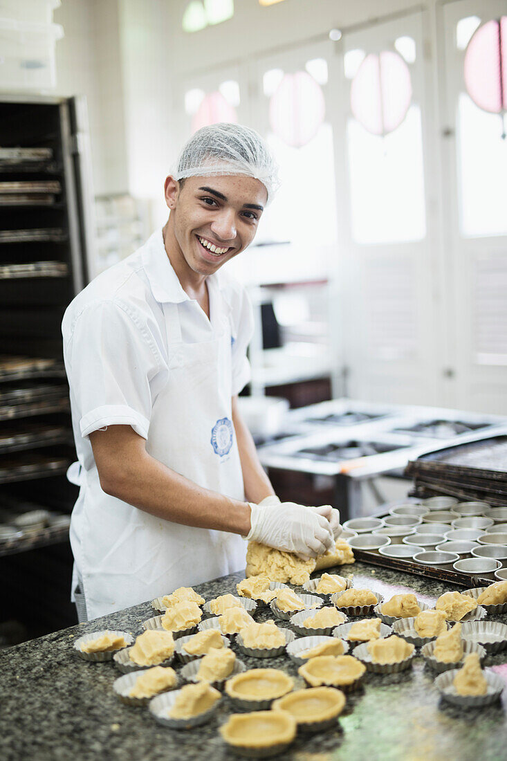 A baker making Portuguese custard tarts in the Confeitaria Colombo, a famous cafe in central Rio de Janeiro, Brazil, South America