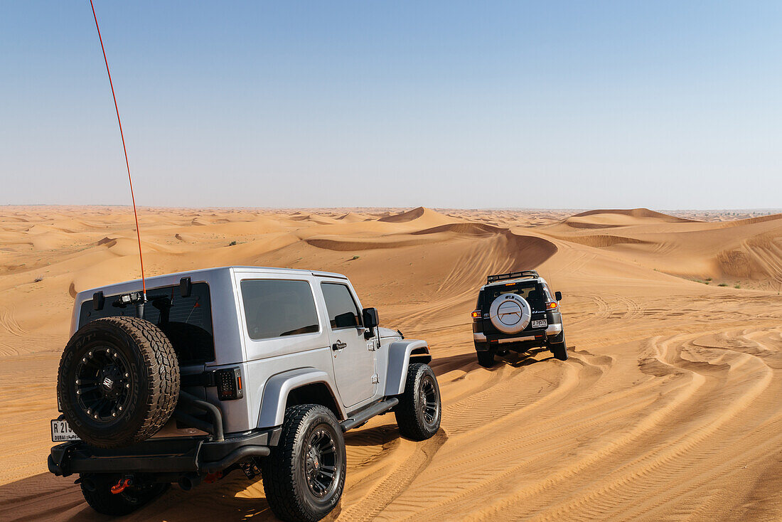 Off road vehicles on sand dunes near Dubai in the United Arab Emirates, Middle East