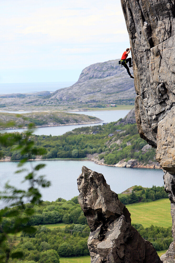 A climber scales a difficult route in the Hanshallaren Cave, Flatanger, Norway, Scandinavia, Europe