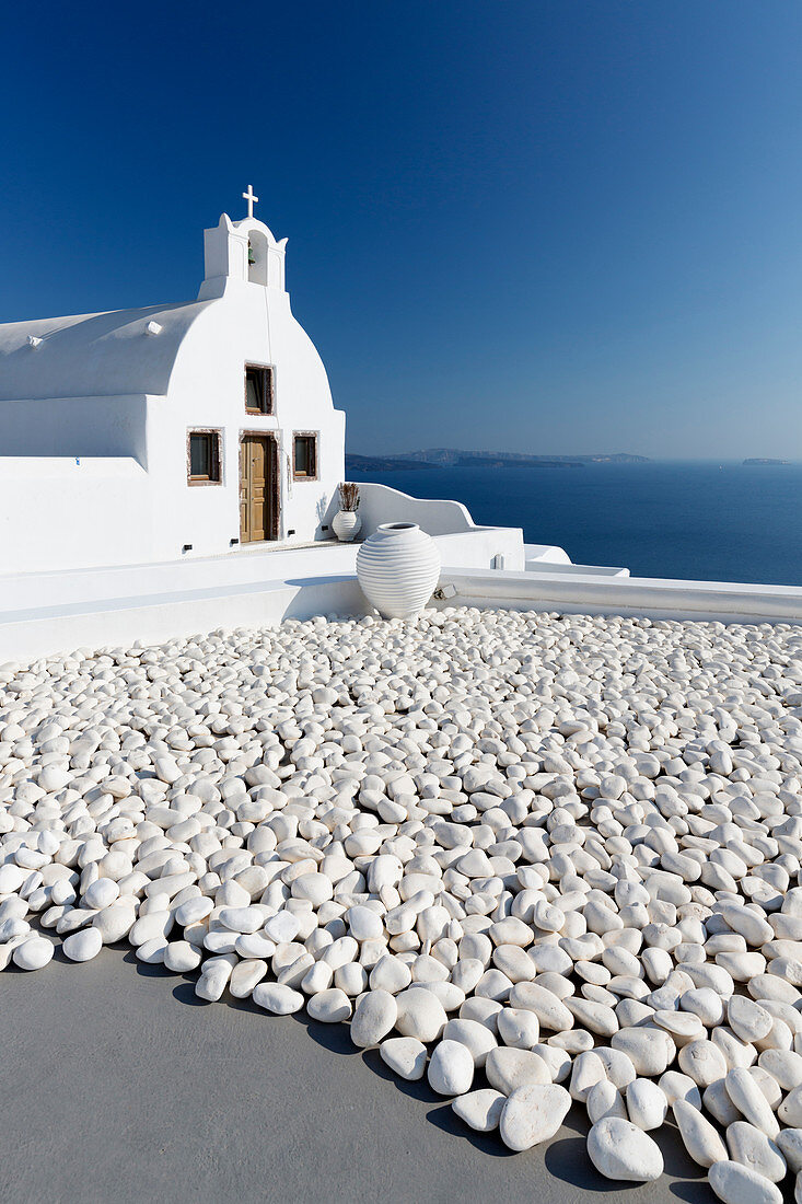 Small whitewashed church against blue sea and sky, Finikia, near Oia, Santorini, Cyclades, Greek Islands, Greece, Europe