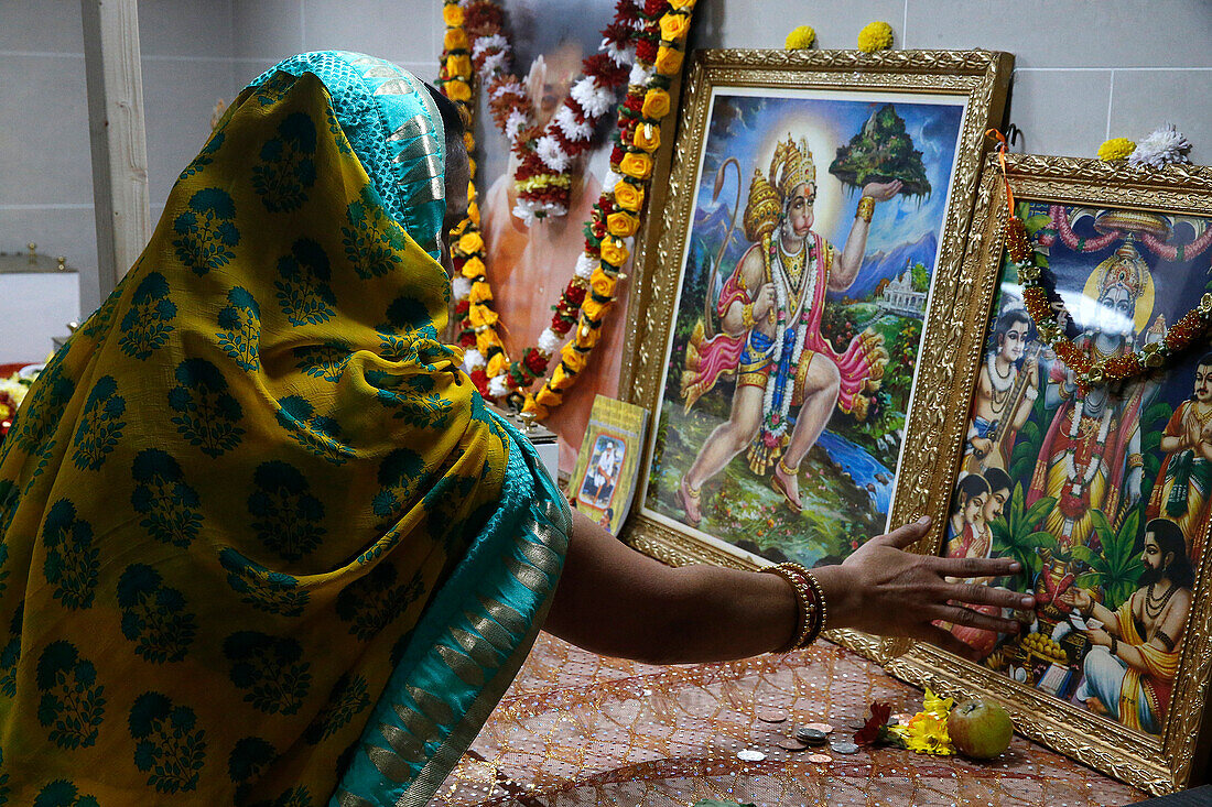 Faithful touching pictures of deities, Shree Ram Mandir, Leicester, Leicestershire, England, United Kingdom, Europe