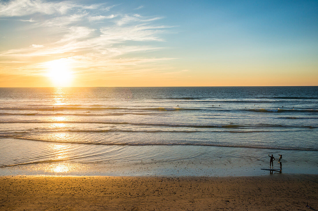 Couple in backlight walking at sunset, Del Mar, California, United States of America, North America