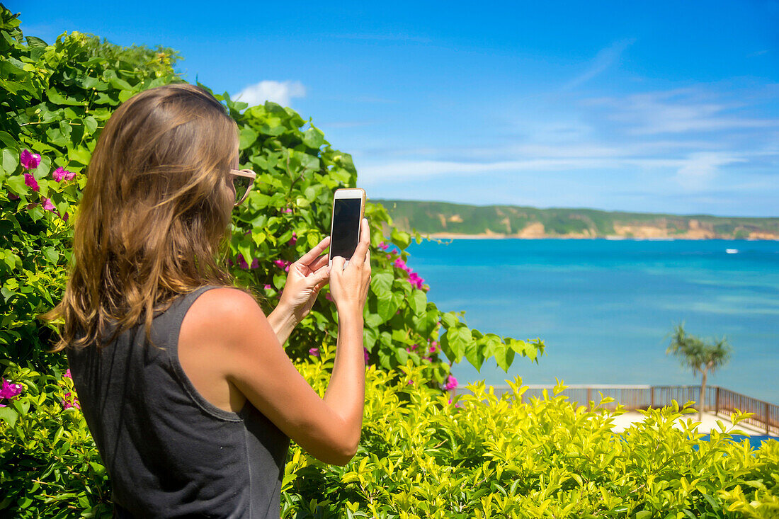 Female tourist taking picture with smart phone