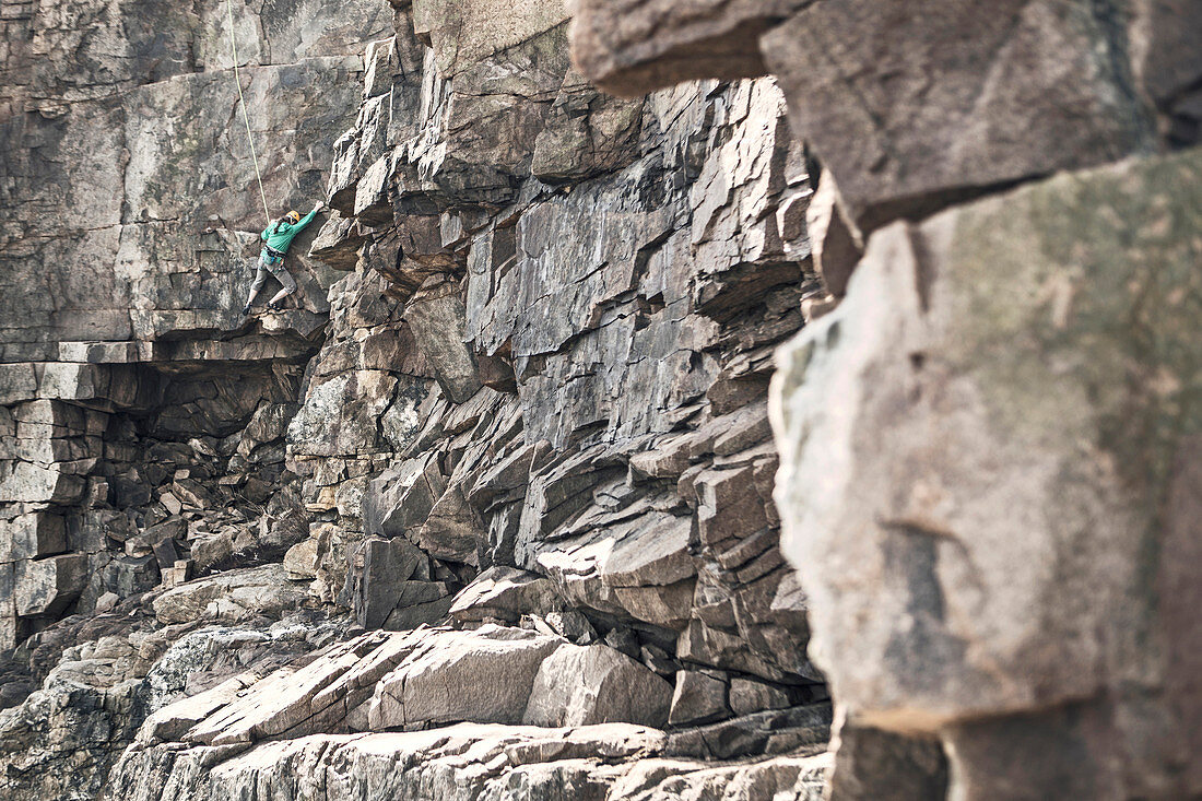 Photograph of rock climber climbing Otter Cliffs, Acadia National Park, Maine, USA