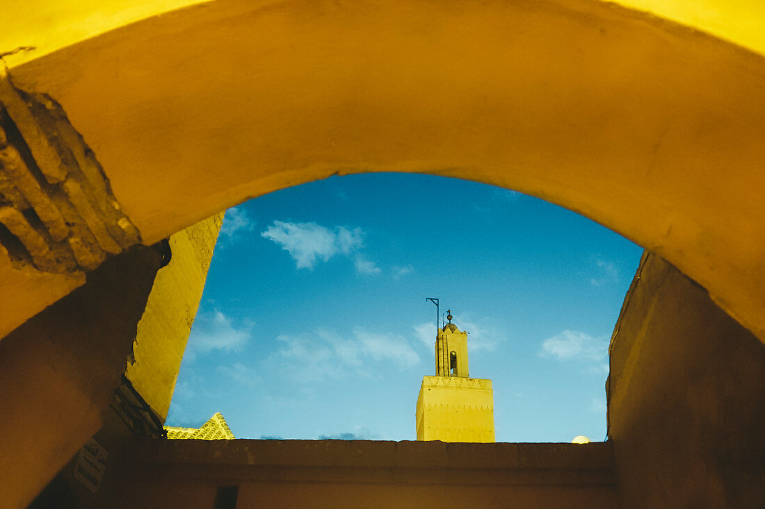 Photograph with Koutoubia Mosque minaret seen through arch, Medina, Marrakech, Morocco