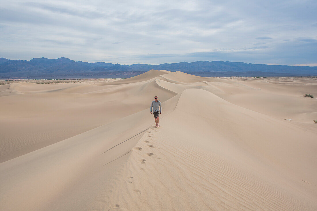 Man walking alone on Mesquite Flat Sand Dunes in Death Valley National Park, California, USA