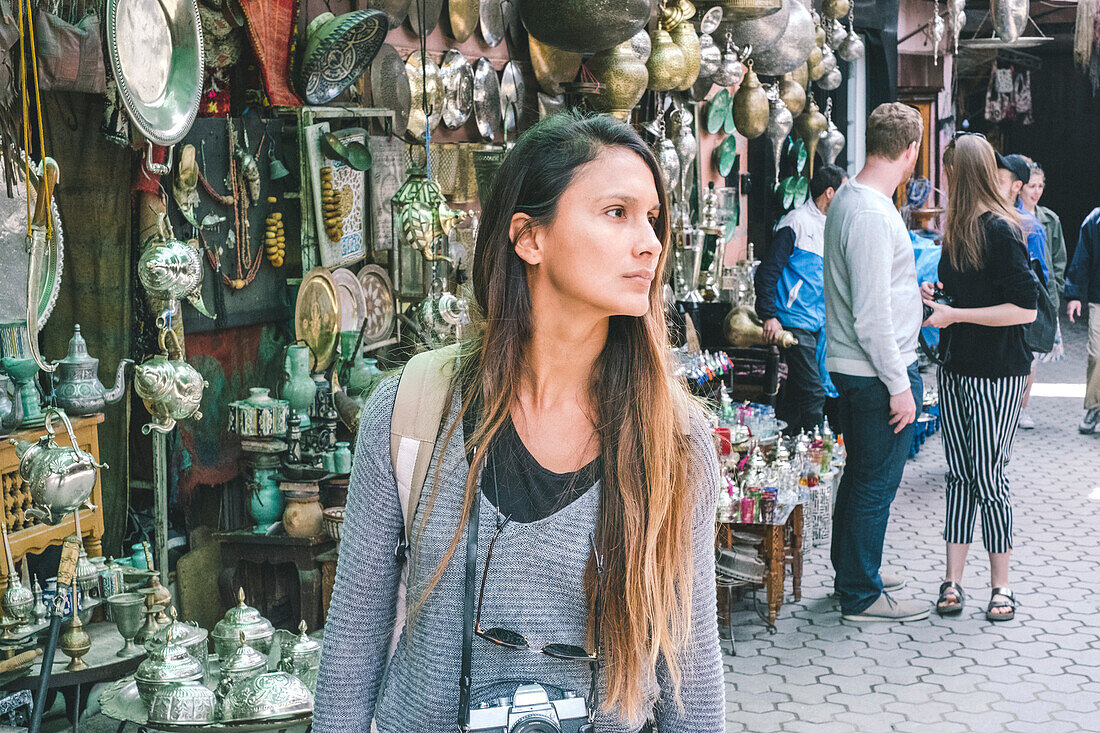 Female tourist walking in Jemaa el-Fnaa souk in Marrakesh, Morocco