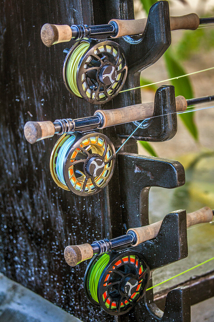 Fishing rods resting in a rack at a Belizean lodge