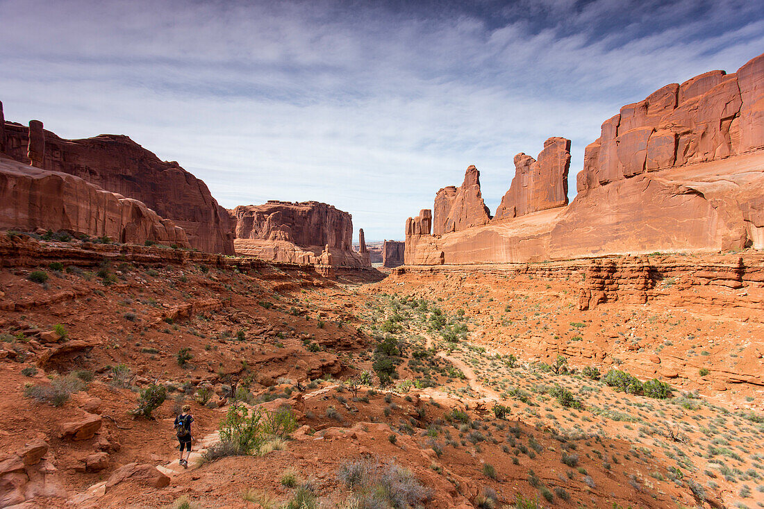 Hiker Hiking Down The Park Ave Trail In Arches National Park