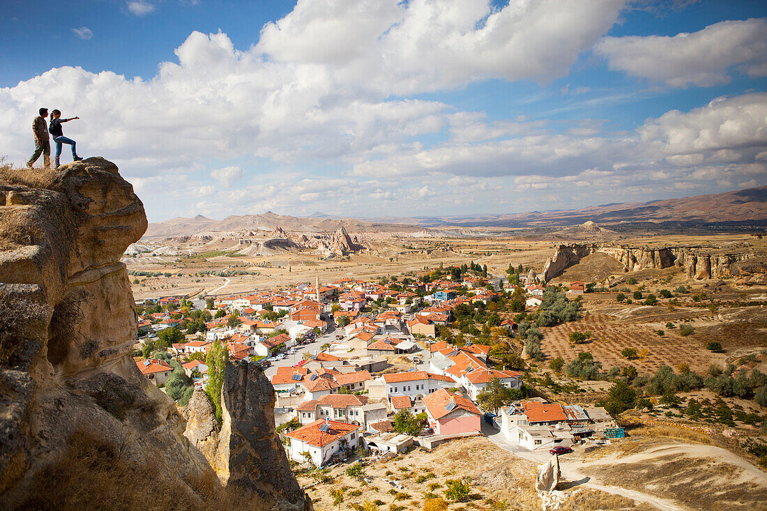 Two hikers over looking Cavusin, an old Greek village in Cappadocia Turkey. It has a 5th century church of Saint John, and a marvelous view into the Rose and Red Valleys.