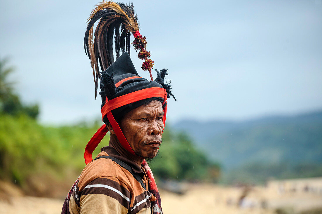 Man wearing hat and traditional costume, Pasola festival, Sumba Island, Indonesia