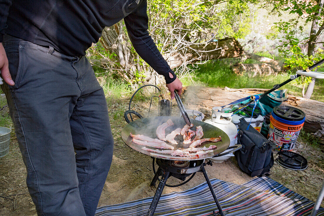 Person Cooking Bacon At Campsite, Dinosaur National Monument, Utah, Usa