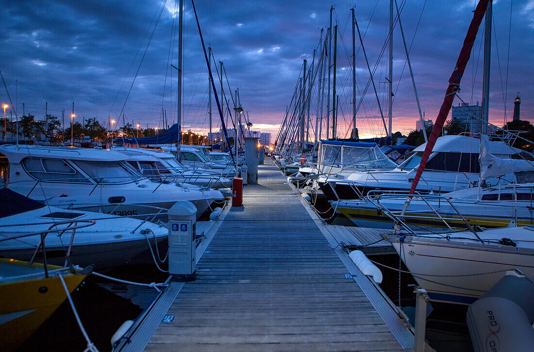 'Cloudy sunset on a marina in Lorient.  Lorient; Breton: An Oriant, is a commune and a seaport in the Morbihan department in Brittany in north-western France.'