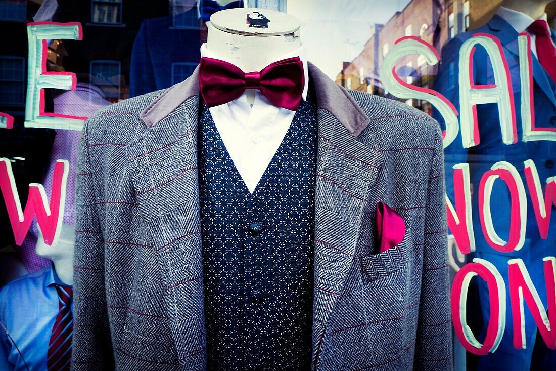 Close-up of a headless mannequin wearing a tweed blazer, vest, shirt and bow tie. Petticoat Lane Market, East End, London, England