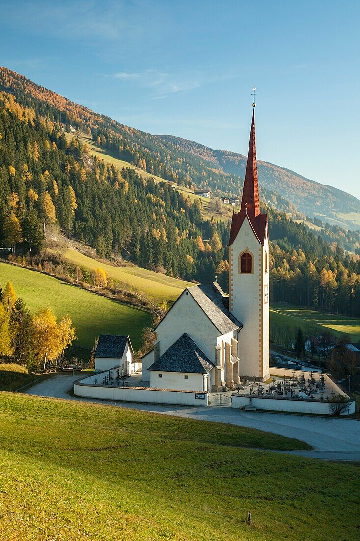 Autumn morning at the iconic alpine church in Winnebach, South Tyrol, Italy.