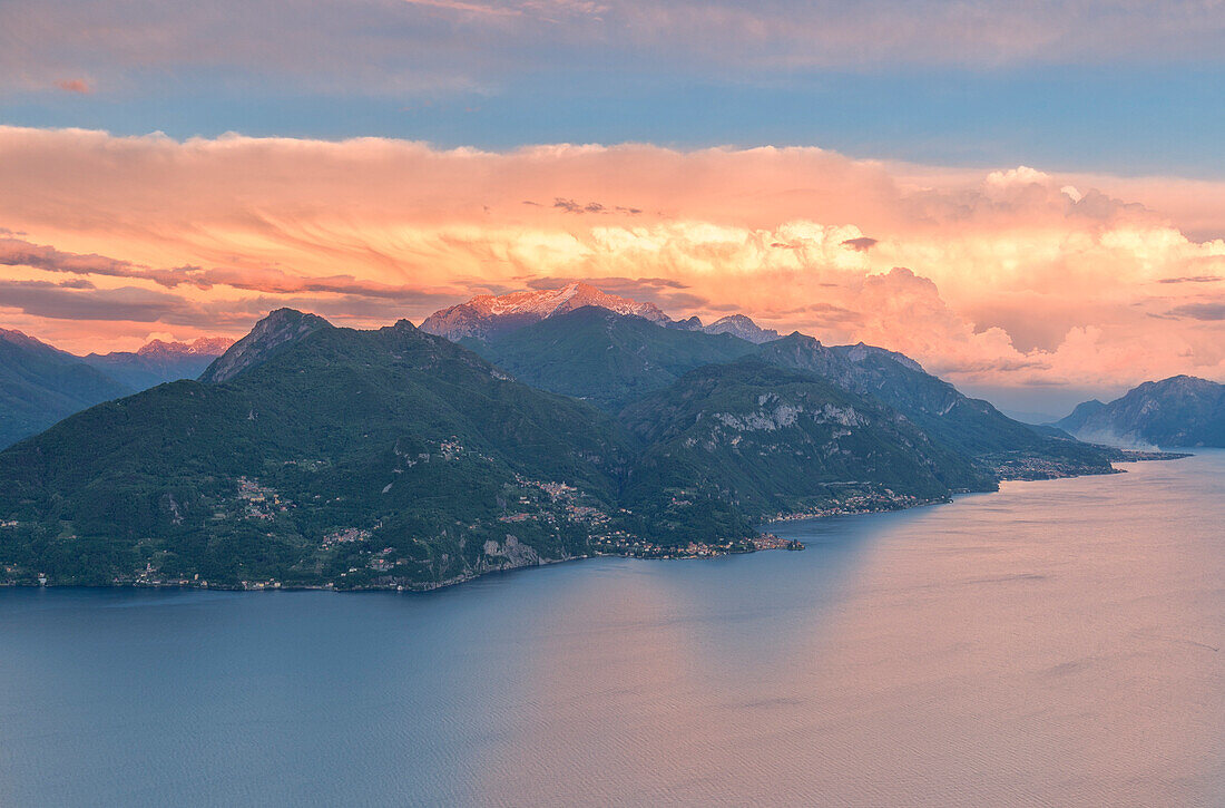 Storm clouds at unset over mountains of lake Como and Valsassina seen from the slopes of the mountains over Menaggio Lombardy, Italy, Europe