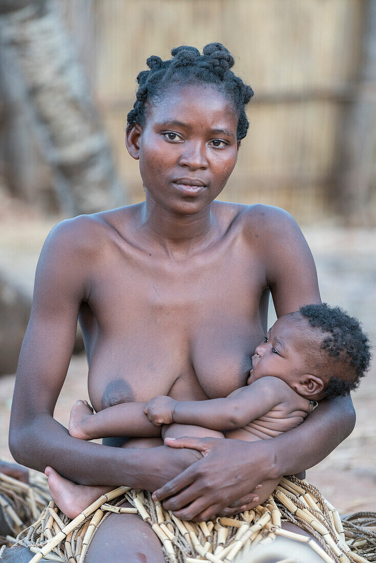 Mafwe woman breastfeeding her son, Mafwe Living Museum, Zambesi region, Namibia