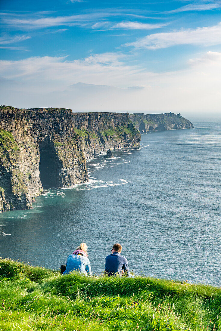 Couple admiring the landscape, Cliffs of Moher, Liscannor, Co, Clare, Munster province, Ireland