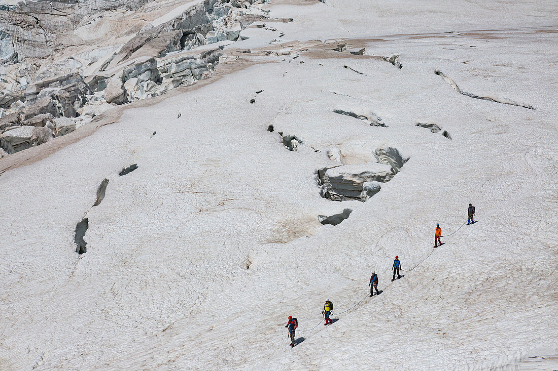 Mountaineers walk on Lys glacier near the Gnifetti refuge in Monte Rosa Massif (Gressoney, Lys Valley,  Aosta province, Aosta Valley, Italy, Europe)