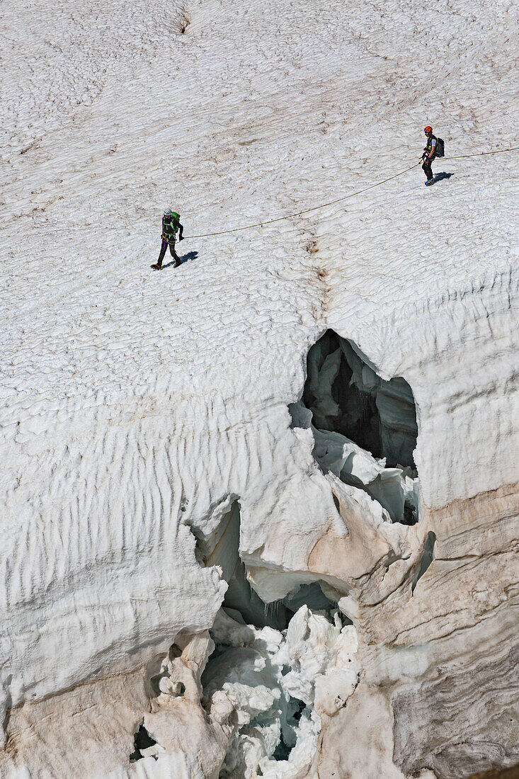 Mountaineers walk on Lys glacier near the Gnifetti refuge in Monte Rosa Massif (Gressoney, Lys Valley,  Aosta province, Aosta Valley, Italy, Europe)