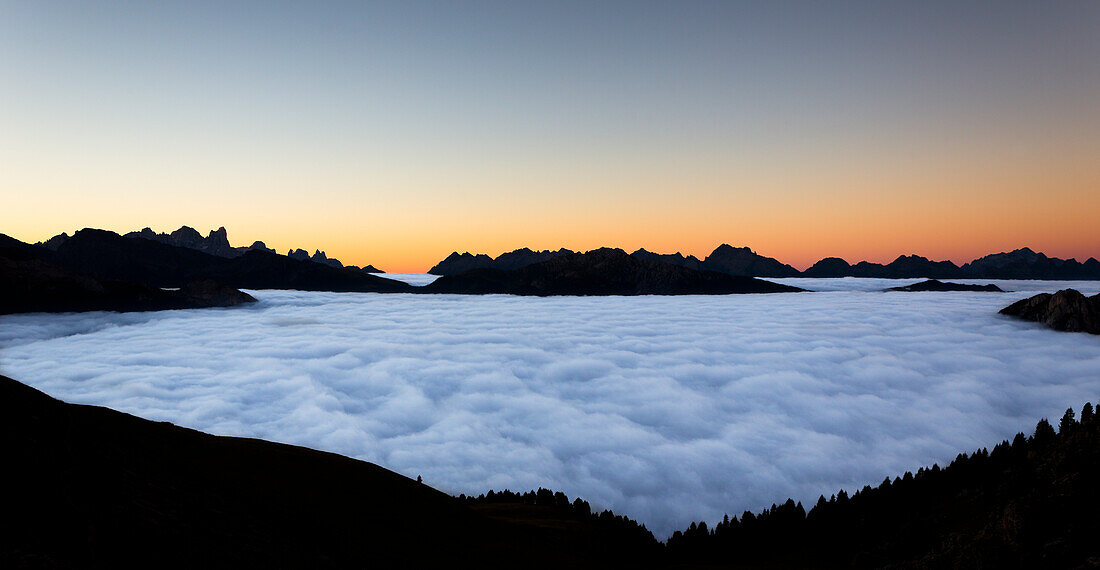 a suggestive sunrise from the Rosengarten Group with all the Fassa valley covered by clouds, Trento province, Trentino Alto Adige, Italy
