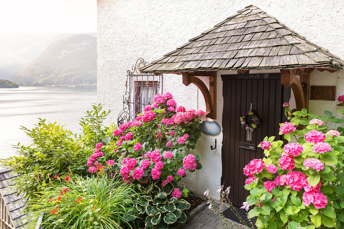 Detail über den blühenden Eingang eines Hauses im Dorf Hallstatt, Oberösterreich, Region Salzkammergut, Österreich