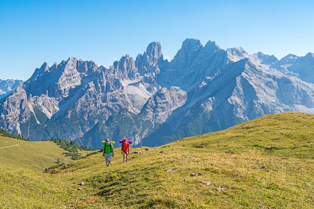 Prato Piazza/Plätzwiese, Dolomites, South Tyrol, Italy, Two children hike over the Prato Piazza/Plätzwiese, In the background the mountain group of Cristallo