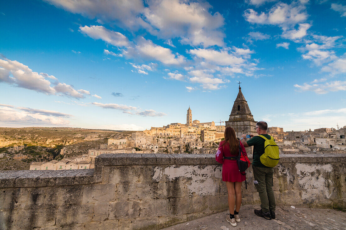 Tourists admire the ancient town and historical center called Sassi perched on rocks Matera Basilicata Italy Europe