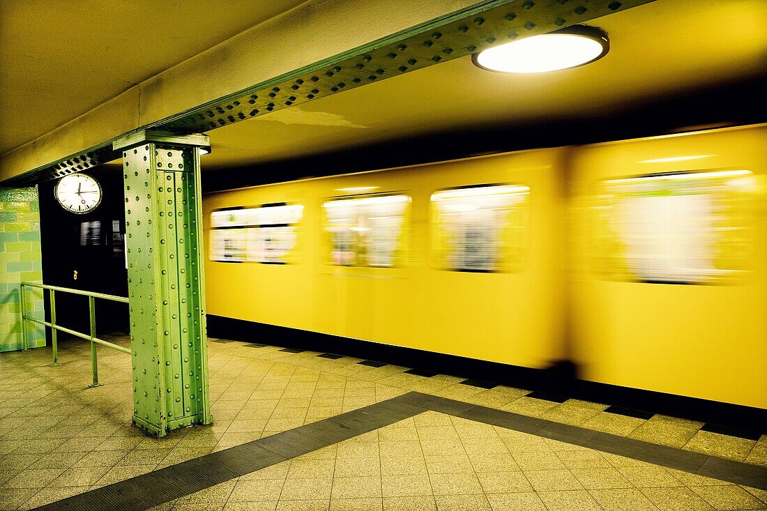 Moving train in Voltastrasse subway station. Berlin, Germany