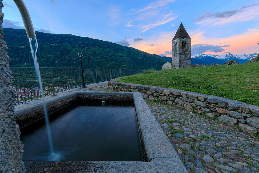 Stone fountain next to bell tower, Xenodochio of Santa Perpetua, Tirano, province of Sondrio, Valtellina, Lombardy, Italy, Europe