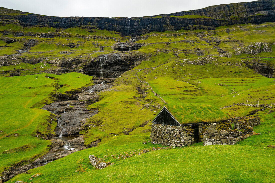 Grasstop roof house before a waterfall, Saksun, Streymoy, Faroe Islands, Denmark, Europe