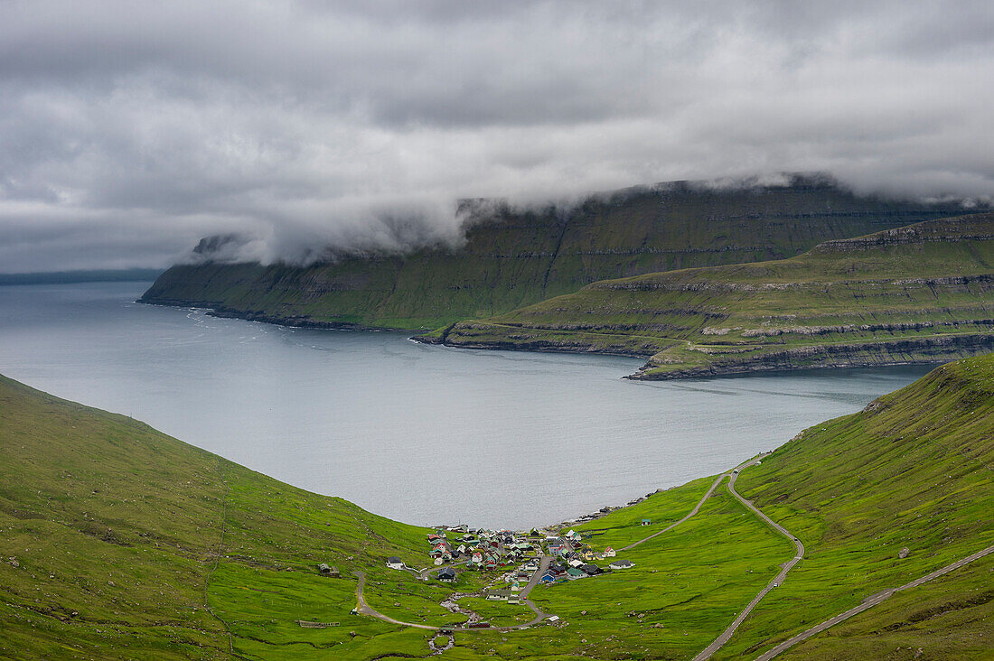 Little village of Funnigur in a huge fjord, Estuyroy, Faroe Islands, Denmark, Europe