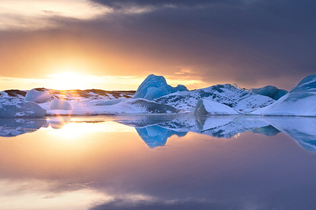 Icebergs covered in dusting of snow, winter, sunset, Jokulsarlon Glacial Lagoon, South Iceland, Polar Regions