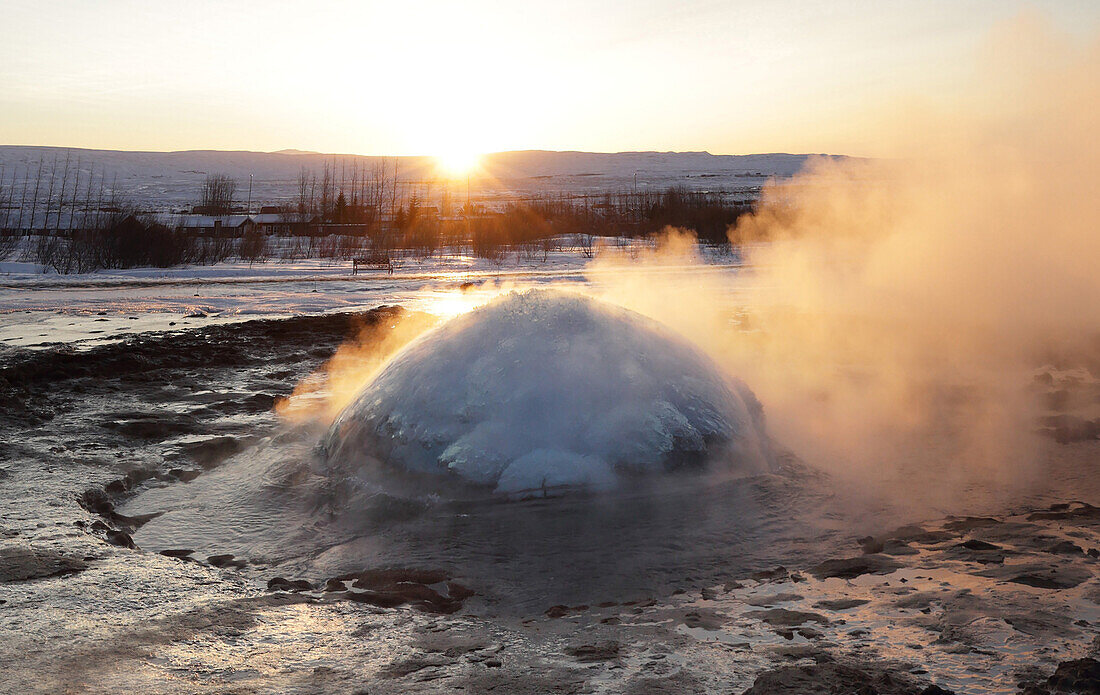 Strokkur-Geysir, der bei Sonnenaufgang im Winter ausbricht, geothermisches Gebiet neben dem Hvita-Fluss, Geysir, Island, Polargebiete