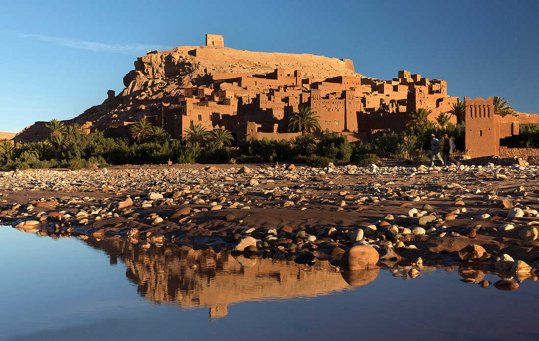 The ancient Kasbah Ait Benhaddou bathed in morning light and reflecting in river, UNESCO World Heritage Site, near Ouarzazate, Morocco, North Africa, Africa