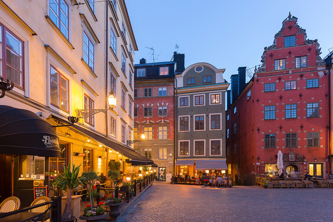 Restaurant and colourful buildings on Stortorget, Old Town Square in Gamla Stan at dusk, Stockholm, Sweden, Scandinavia, Europe