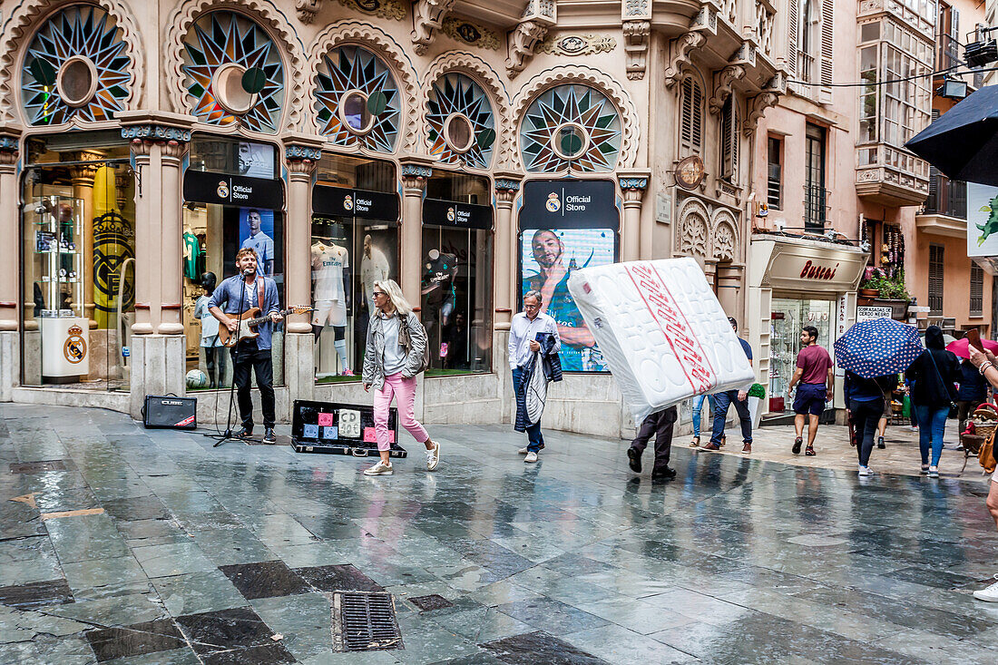 Street scene with the street artist and the matrass in front of a modernist building next to Plaza Cort in the old town of Palma, Old town, Palma de Mallorca, Majorca, Balearic Islands, Mediterranean Sea, Spain, Europe