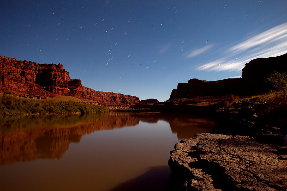Time exposure of Moonlight and streaking stars illuminating Colorado River, Canyonlands National Park, Utah