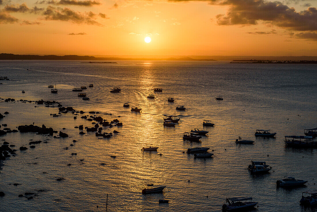 Photograph with silhouettes of boats in sea at sunset, Morro de Sao Paulo, south Bahia state, Brazil