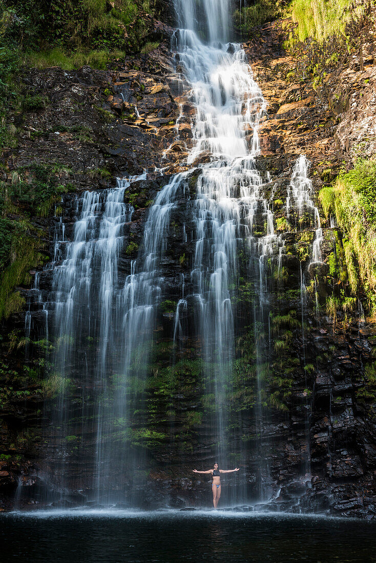 Young woman posing in Farofa Waterfall in Serra do Cipo National Park, MG, Brazil