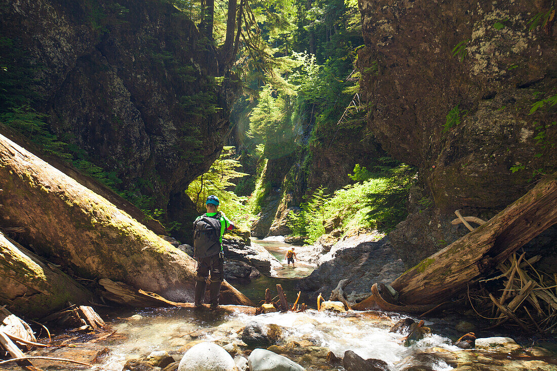 Photograph of adventurous man canyoneering in Deneau Creek, Hope, British Columbia, Canada