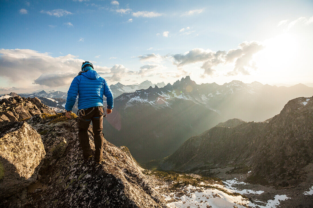 Photograph with rear view of mountain climber in North Cascade Mountain Range, Chilliwack, British Columbia, Canada
